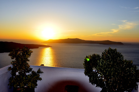 View of the famous island desantorini in greece at sunsetの写真素材