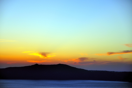 View of the famous island desantorini in greece at sunsetの写真素材