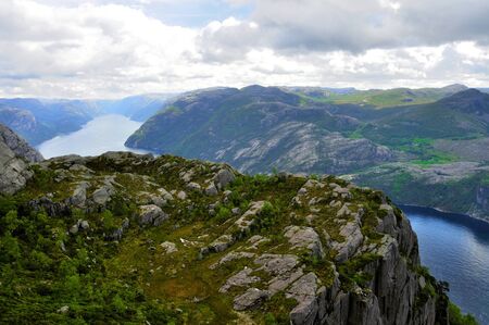 tourists in preikestolen or pulpit in Norway on a day with cloudsの写真素材