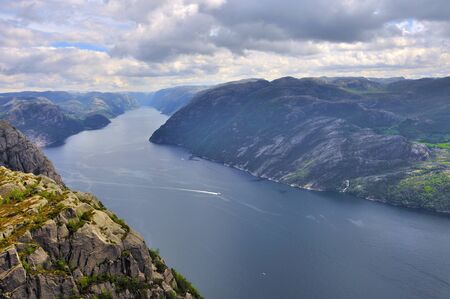 tourists in preikestolen or pulpit in Norway on a day with cloudsの写真素材