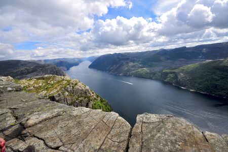 tourists in preikestolen or pulpit in Norway on a day with cloudsの写真素材