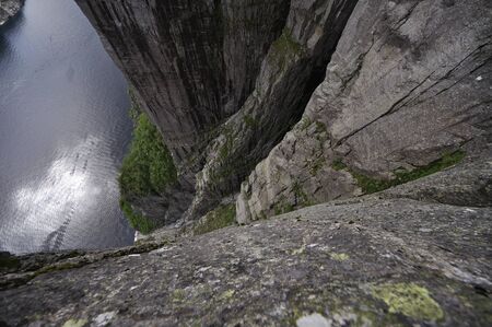 tourists in preikestolen or pulpit in Norway on a day with cloudsの写真素材