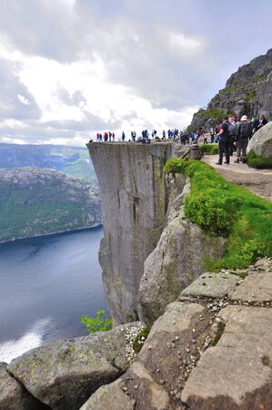 LYSEFJORD-NORWAY, 05JUNE-2017  tourists in preikestolen or pulpit in Norway on a day with cloudsのeditorial素材
