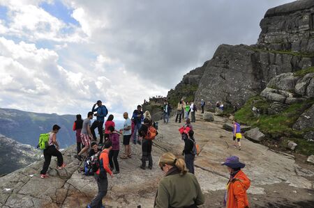 LYSEFJORD-NORWAY, 05JUNE-2017  tourists in preikestolen or pulpit in Norway on a day with cloudsのeditorial素材