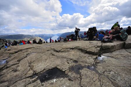LYSEFJORD-NORWAY, 05JUNE-2017  tourists in preikestolen or pulpit in Norway on a day with cloudsのeditorial素材