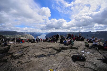 LYSEFJORD-NORWAY, 05JUNE-2017  tourists in preikestolen or pulpit in Norway on a day with cloudsのeditorial素材
