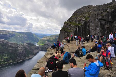 LYSEFJORD-NORWAY, 05JUNE-2017  tourists in preikestolen or pulpit in Norway on a day with cloudsのeditorial素材