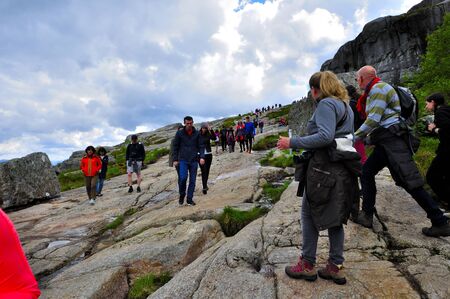 LYSEFJORD-NORWAY, 05JUNE-2017    tourists in preikestolen or pulpit in Norway on a day with cloudsclimb to the prektestolen or pulpit in Norwayclimb to the prektestolen or pulpit in Norwayのeditorial素材