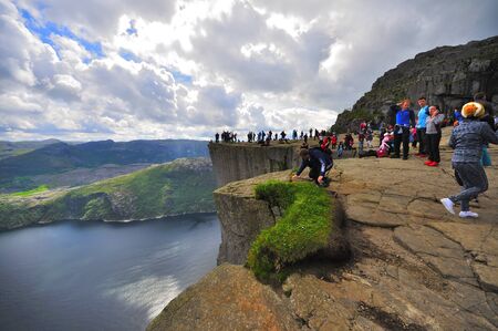 LYSEFJORD-NORWAY, 05JUNE-2017  tourists in preikestolen or pulpit in Norway on a day with cloudsのeditorial素材
