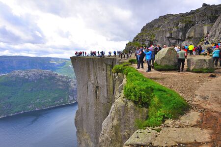 LYSEFJORD-NORWAY, 05JUNE-2017  tourists in preikestolen or pulpit in Norway on a day with cloudsのeditorial素材