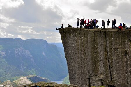 LYSEFJORD-NORWAY, 05JUNE-2017  tourists in preikestolen or pulpit in Norway on a day with cloudsのeditorial素材