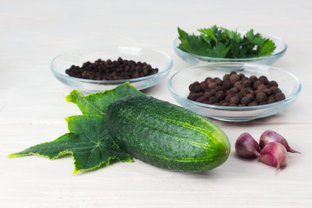 fresh cucumber with green leaves on wooden tableの写真素材