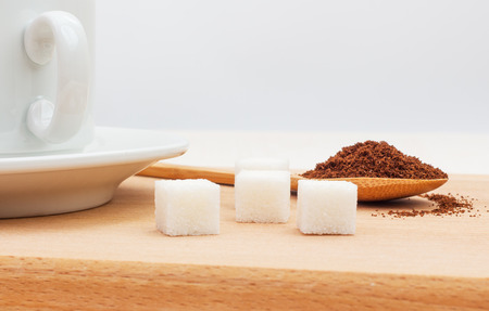 sugar, ground coffee in a wooden spoon on the tableの写真素材