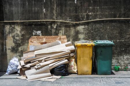 Recycle garbage waste outdoors front cement wall, plastic bin of garbage, bin trash.の写真素材