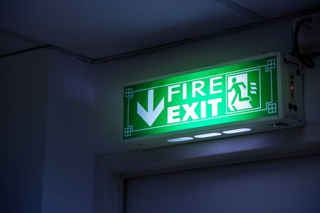 Fire exit, green emergency exit sign. Background, doorway.の写真素材