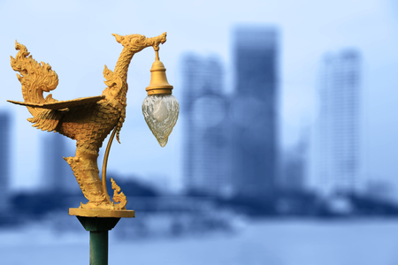 Golden swan lamp, Thai art traditional style on blurry city backgroundの写真素材