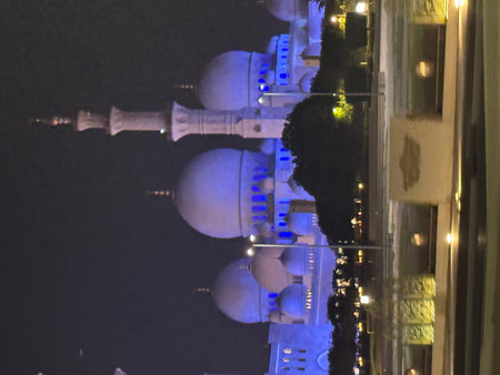 Night view of the Sheikh Zayed Grand Mosque in Abu Dhabi, UAE, beautifully illuminated with blue lighting, showcasing its magnificent domes and towering minarets. Perfect for themeの写真素材