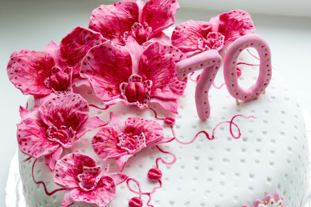 sweet pink orchids white anniversary cake closeupの写真素材