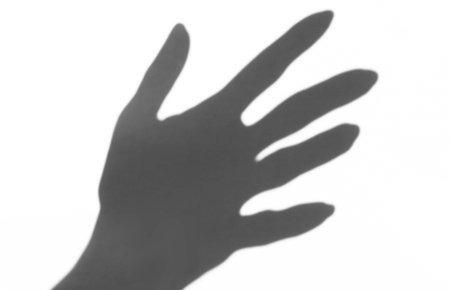 the shadow of the hand white background closeup