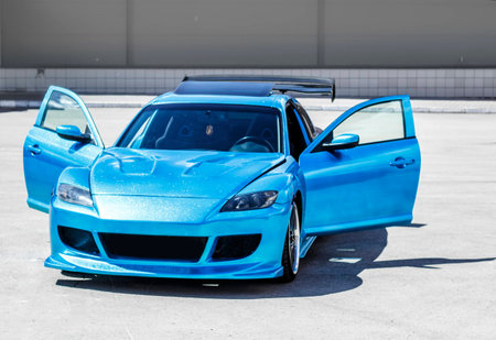 Blue sport car on race way. Closeup capture.