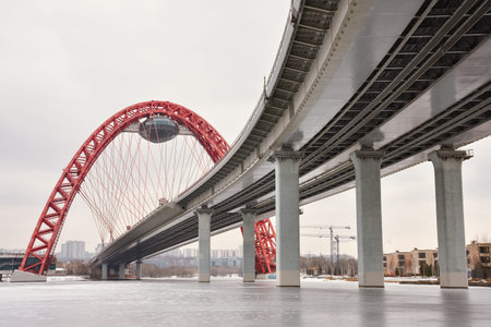 bottom view of the road bridge with a red arch, the picturesque bridge across the Moscow River, the...