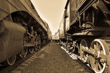 between cars of old trains, between two old trains, black and white vintage photo of trainsの写真素材