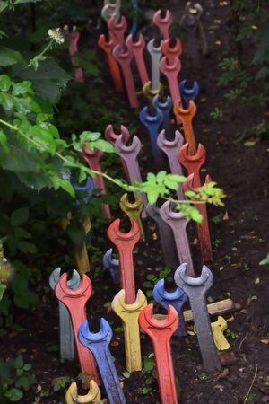 Multi-colored wrenches in the groundの写真素材