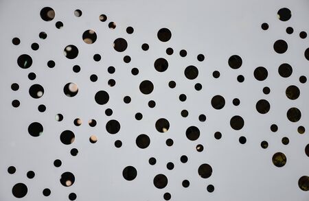 Background from a large number of round holes of different diameter, many holesの写真素材