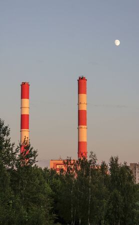two factory pipes and the moon, two striped factory pipesの写真素材