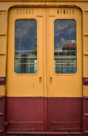 metal doors on the train, orange train doors, yellow-red doorsの写真素材