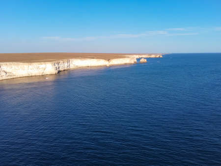 Tarhankut Cape with turquoise water on the western coast of Crimea peninsula. Summer seascape, famous travel destination. Picturesque seascape, Crimea coast beach The Black sea Yalta mountains. A rocky cliff out into the seaの写真素材