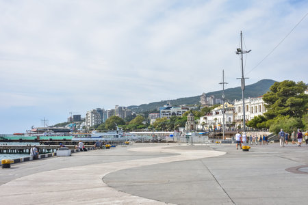 Yalta, Ukraine - September 13, 2020: Embankment in the resort town of Yalta, People walk along the...