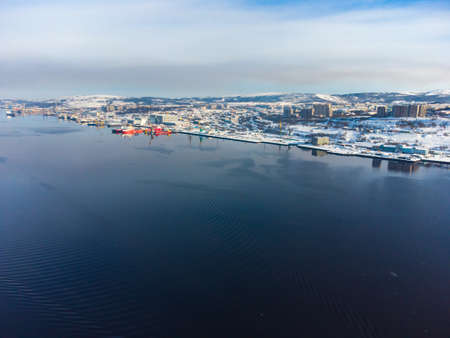 unfrozen sea against the backdrop of snow-capped mountains. view from aboveの写真素材