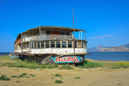 Sudak, Crimea, Russia - July 10, 2021: abandoned steamer stranded, rusty old cruise steamer, ship skeleton, stranded shipのeditorial素材
