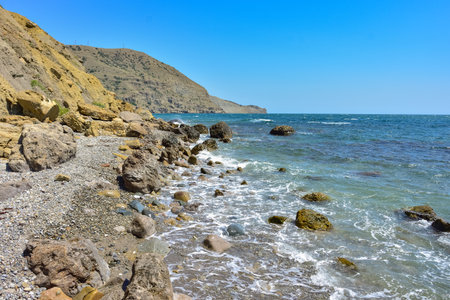 rocky shore of Black Sea, landscape with rocks on seashore, rocks sticking out of seaの写真素材
