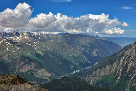 A mountain range with snow and ice on the peaks. The snow is white and the mountains are covered in...