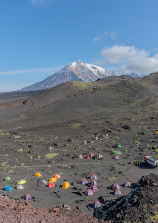 Group of tents are set up on a mountain. There are many people in the tents.の写真素材
