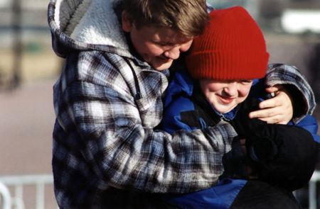 Casual portrait of two brothers outdoors in winter.の写真素材