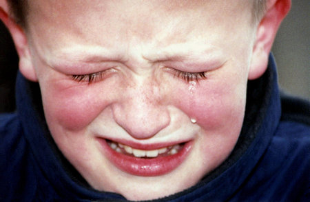Closeup of boy crying.