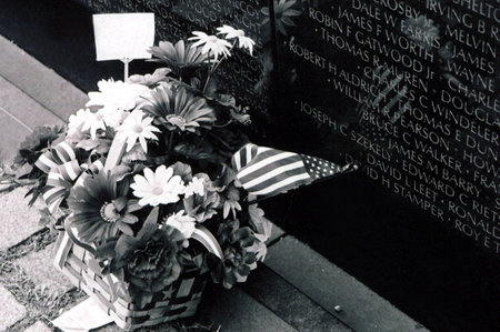 Flowers left at the base of the Vietnam Wall Memorial in Washington, D.C.