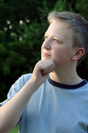Teenage boy in thinking pose.