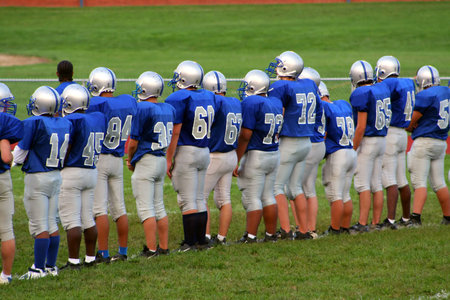 High school football team lined up on field.の写真素材