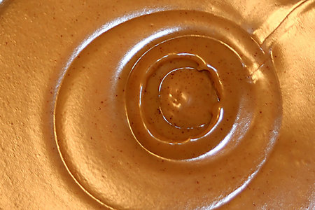 Abstract view of the top of a new jar of peanut butter.の写真素材