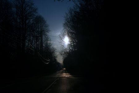 View down a rural road in early morning hours.の写真素材