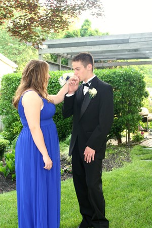 Teen Boy Kissing Prom Date's Hand Outdoorsの写真素材