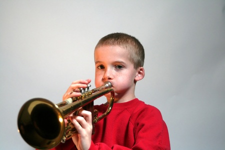 Puffy Cheeked Boy Playing Trumpetの写真素材