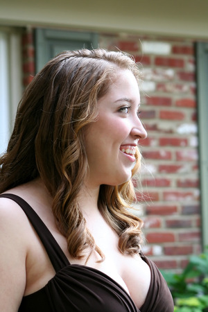 Smiling Teen Girl In Brown Gownの写真素材