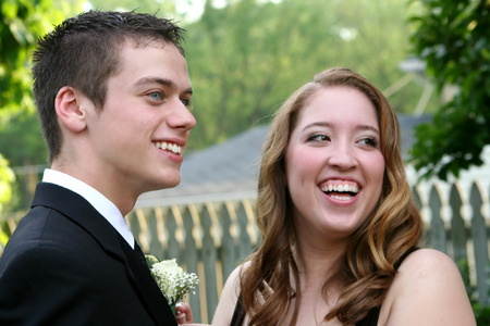 Laughing Prom Couple Showing Boutonniereの写真素材