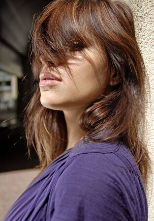 brown hair on the eyes of beautiful city womanの写真素材