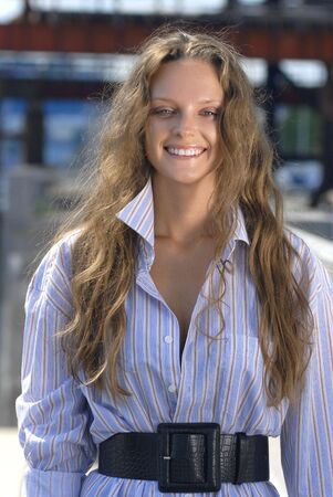 Portrait of a happy young collegian on color backgroundの写真素材